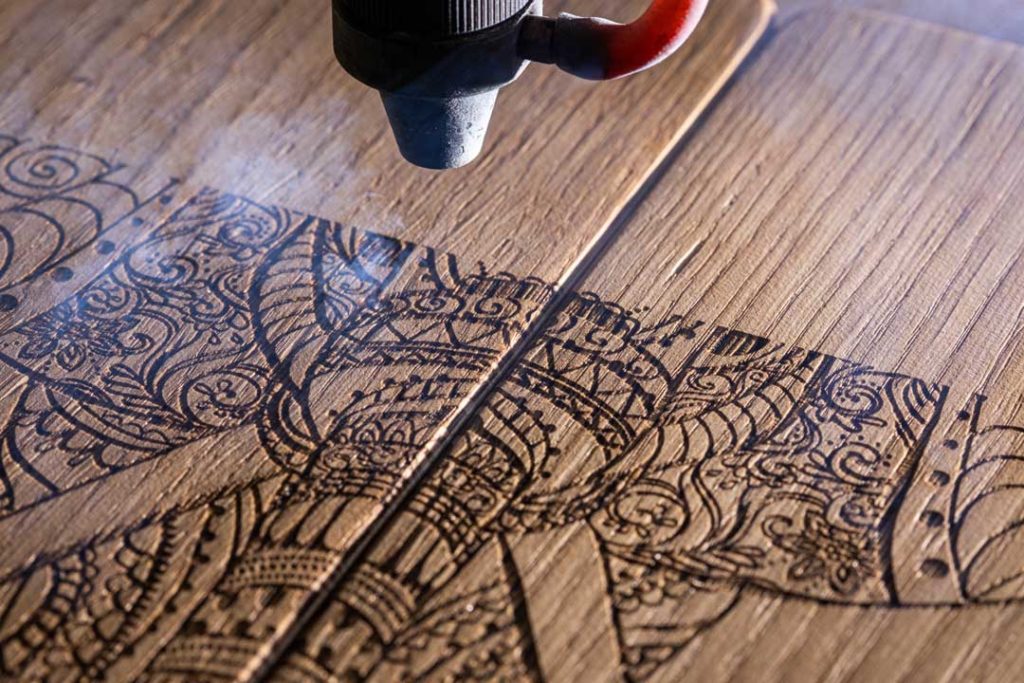 Laser Engraves The Image Of An Indian Elephant On A Wooden Surfa